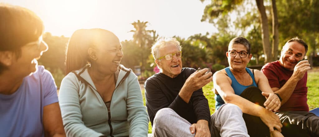 A group of people talking in the park