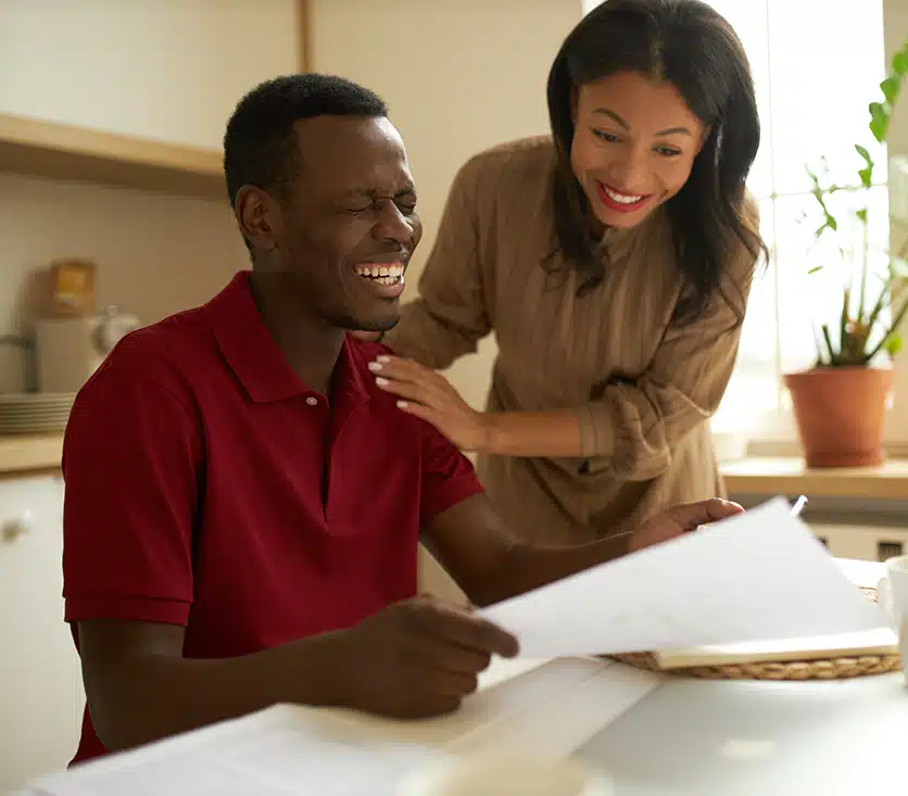 woman helping a man with paperwork